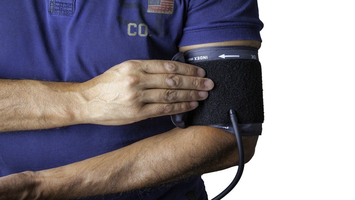 How should you place your arm during a blood pressure